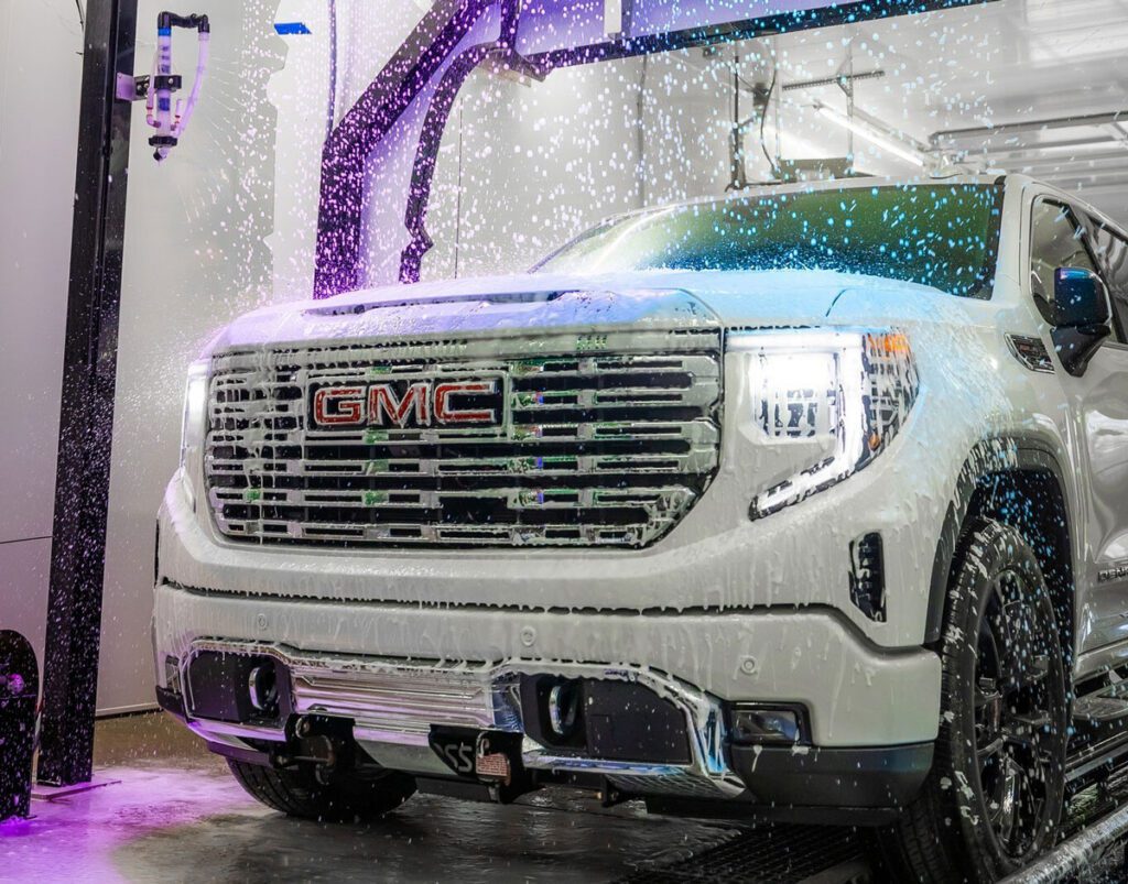 GMC vehicle being showered with car wash chemicals